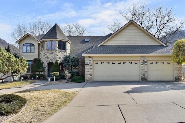 view of front of property with brick siding, roof with shingles, concrete driveway, and an attached garage