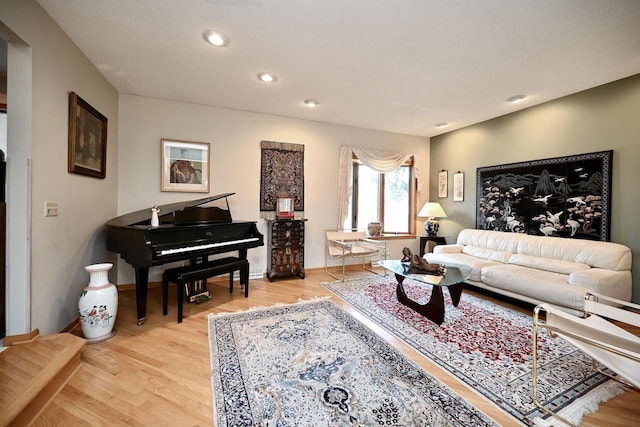 living area with recessed lighting, baseboards, and light wood-style flooring