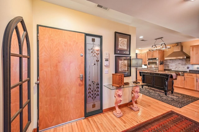 entryway featuring recessed lighting, light wood-style floors, and visible vents