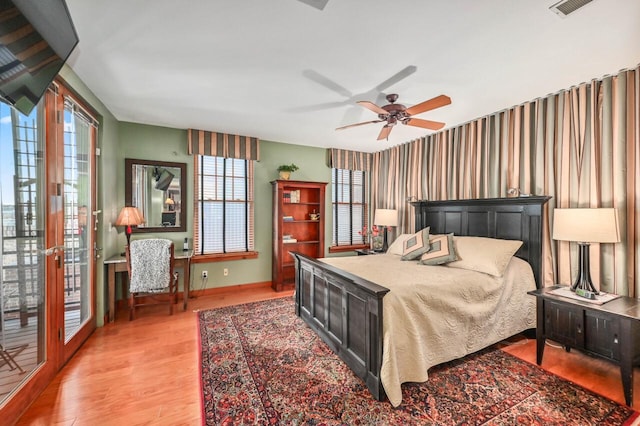 bedroom featuring visible vents, baseboards, ceiling fan, access to outside, and light wood-type flooring