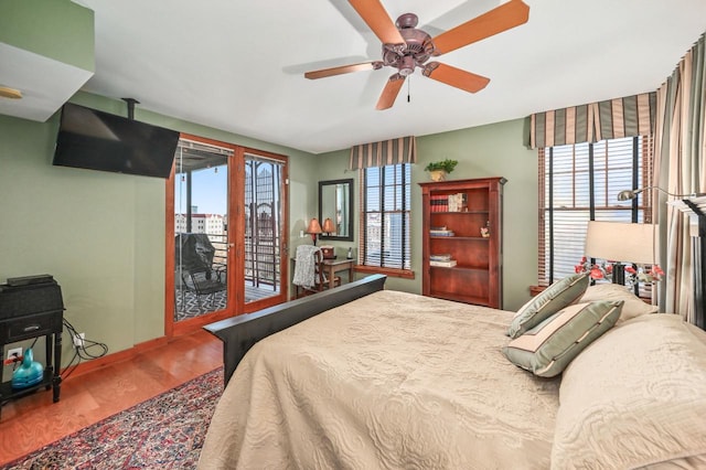 bedroom with access to exterior, wood finished floors, and ceiling fan