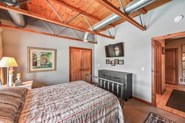 bedroom featuring visible vents, baseboards, carpet, and wood ceiling