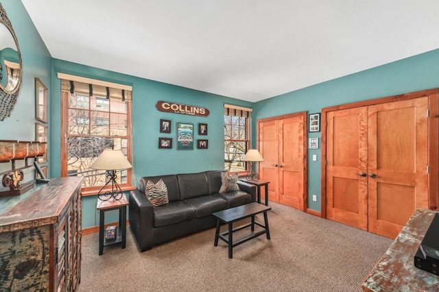 living room with carpet and baseboards