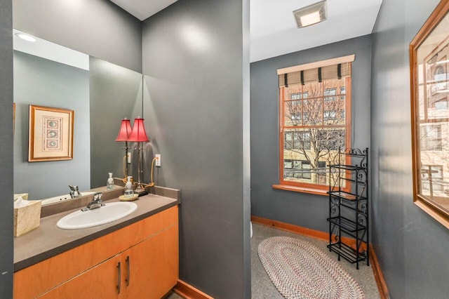 bathroom featuring baseboards and vanity