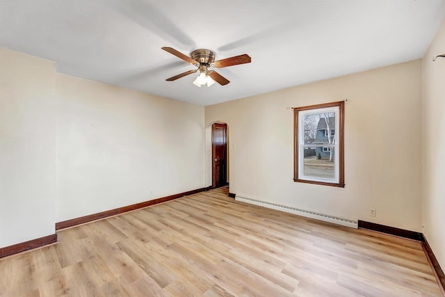 unfurnished room with baseboards, a baseboard radiator, light wood-style flooring, arched walkways, and ceiling fan