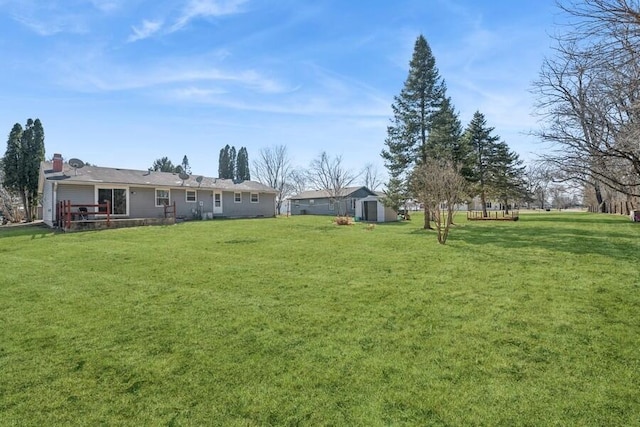 view of yard with an outdoor structure and a storage unit