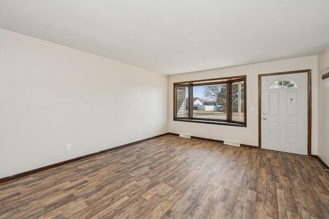 entrance foyer featuring visible vents, baseboards, and wood finished floors