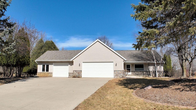 ranch-style house featuring a garage, stone siding, and driveway