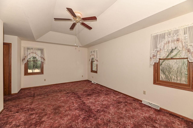 unfurnished room featuring visible vents, a tray ceiling, a ceiling fan, and carpet floors