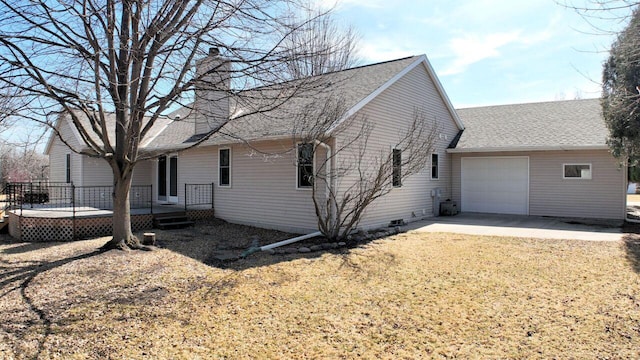 exterior space featuring a deck, a front yard, a shingled roof, a garage, and a chimney