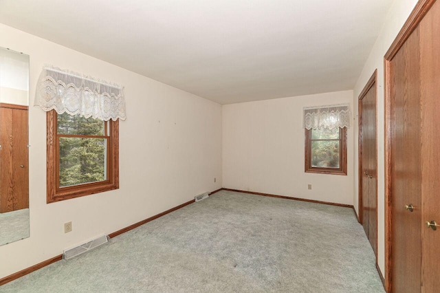 unfurnished bedroom with visible vents, baseboards, and carpet floors