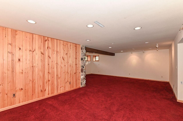 basement with wooden walls, recessed lighting, visible vents, and carpet floors