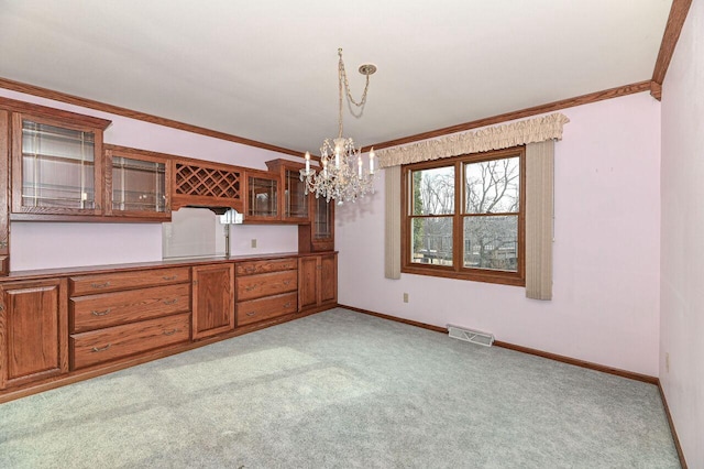 unfurnished dining area featuring light carpet, visible vents, crown molding, and baseboards