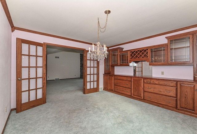 unfurnished dining area featuring light carpet, a notable chandelier, french doors, and crown molding