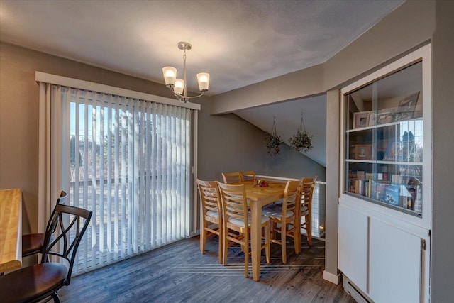 dining space with baseboards, an inviting chandelier, wood finished floors, and vaulted ceiling