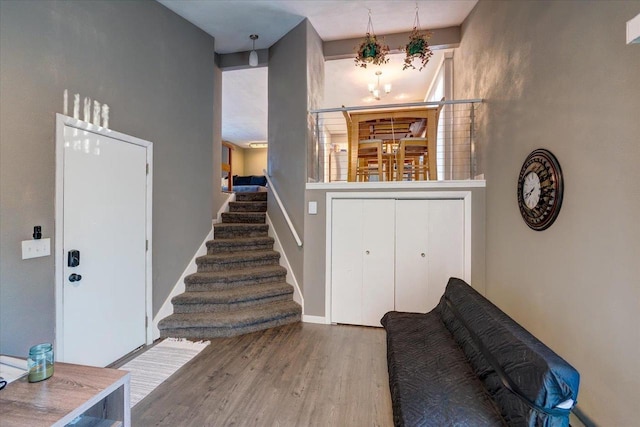 entrance foyer featuring stairway, baseboards, and wood finished floors