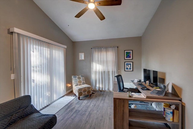 home office featuring lofted ceiling, wood finished floors, and ceiling fan