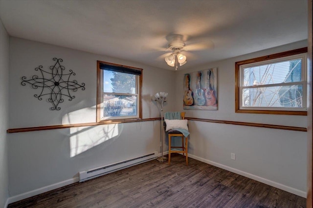 unfurnished room with ceiling fan, wood finished floors, baseboards, and a baseboard radiator