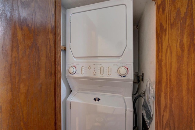 clothes washing area featuring laundry area and stacked washer and dryer