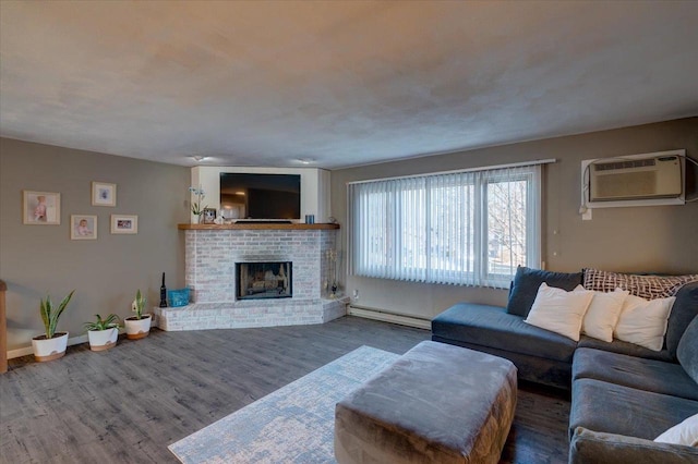 living area featuring wood finished floors, baseboards, a baseboard radiator, a wall mounted AC, and a fireplace