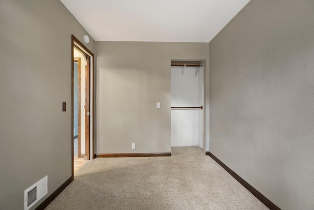 unfurnished bedroom featuring visible vents, baseboards, and carpet