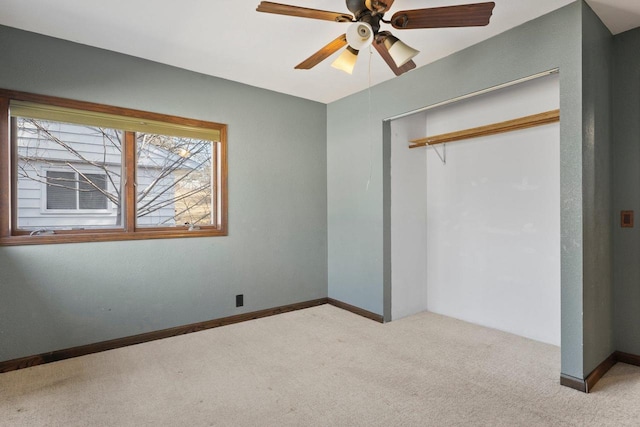 unfurnished bedroom with a closet, carpet flooring, ceiling fan, and baseboards