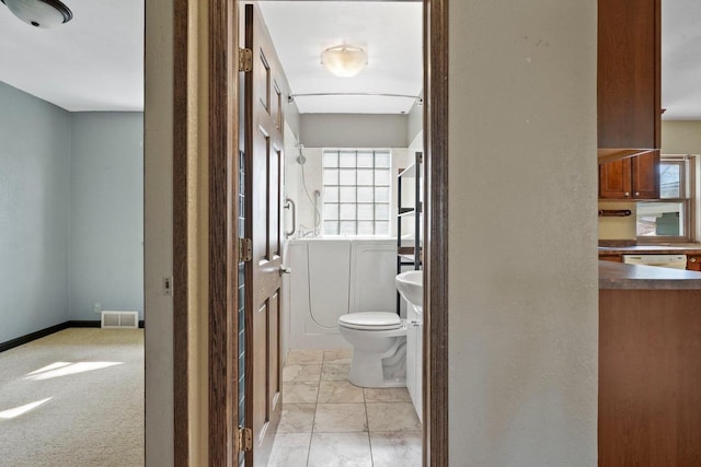 bathroom with visible vents, toilet, a shower, and baseboards