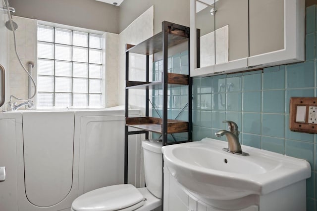 bathroom featuring vanity, decorative backsplash, a shower, tile walls, and toilet