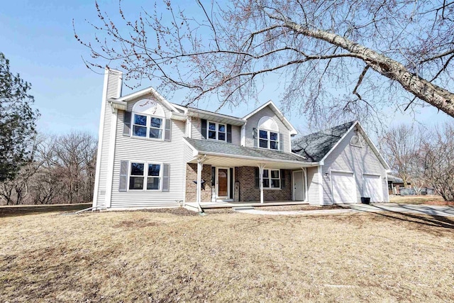 traditional-style home featuring brick siding, a front lawn, a porch, a chimney, and a garage