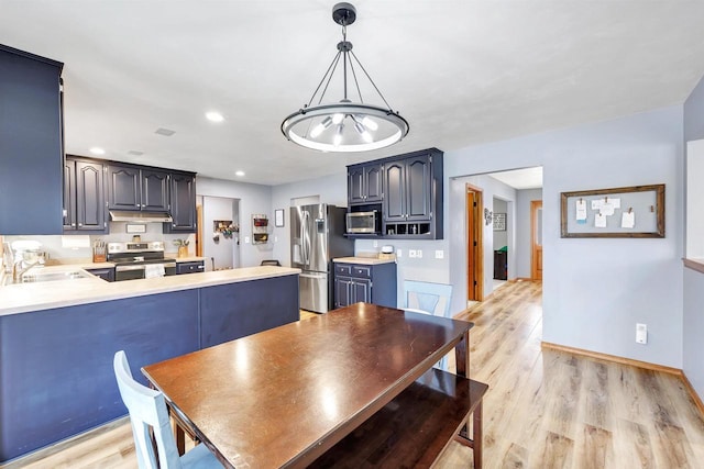 dining area featuring recessed lighting, light wood-type flooring, baseboards, and a chandelier