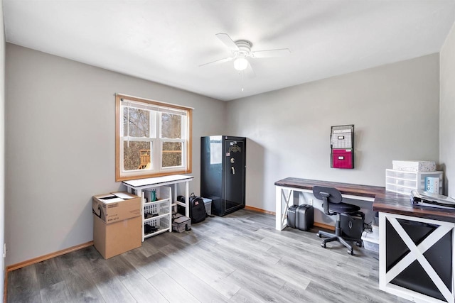 office area with baseboards, ceiling fan, and wood finished floors