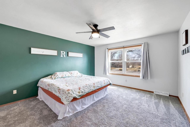 carpeted bedroom featuring visible vents, baseboards, and a ceiling fan