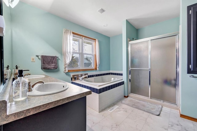 full bath with a garden tub, a stall shower, marble finish floor, and a sink