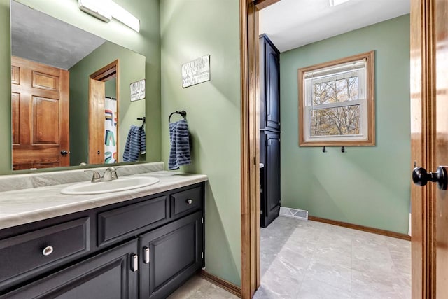 bathroom with baseboards and vanity