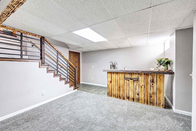 bar featuring stairway, baseboards, carpet floors, a bar, and a paneled ceiling