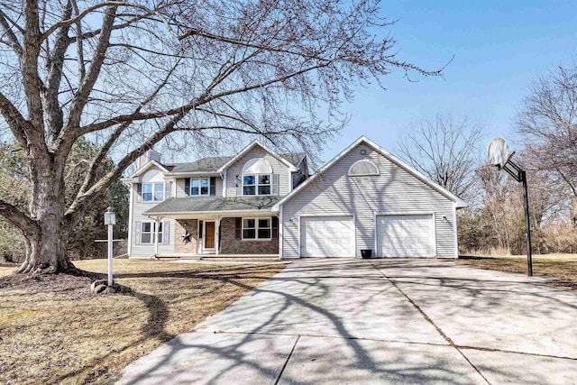 traditional home with driveway, brick siding, covered porch, and an attached garage