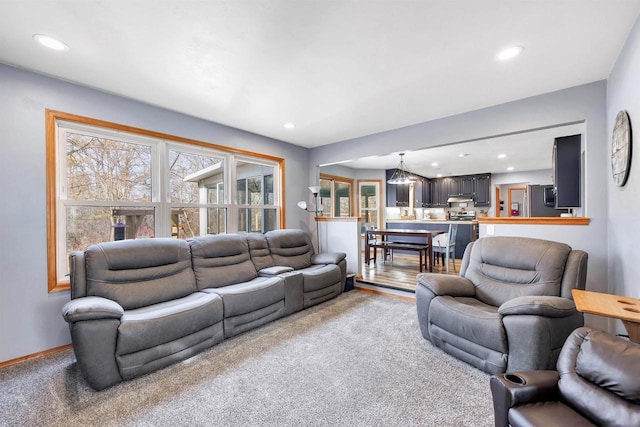 living room with recessed lighting, baseboards, and carpet