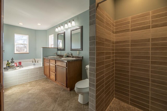 5628 E Eagle Dr, Milton, WI 53563 - bathroom featuring toilet, a bath, tile patterned flooring, and a sink