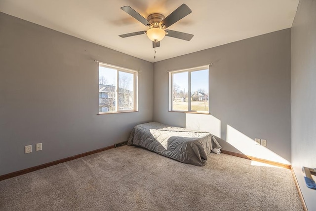 5628 E Eagle Dr, Milton, WI 53563 - carpeted bedroom featuring visible vents, baseboards, and ceiling fan