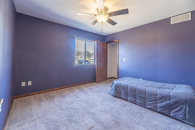 5628 E Eagle Dr, Milton, WI 53563 - unfurnished bedroom featuring carpet flooring, baseboards, visible vents, and ceiling fan