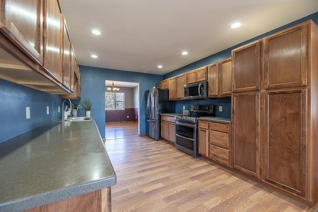 5628 E Eagle Dr, Milton, WI 53563 - kitchen featuring recessed lighting, a sink, light wood-style floors, appliances with stainless steel finishes, and a notable chandelier
