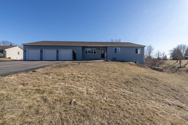 5628 E Eagle Dr, Milton, WI 53563 - ranch-style home featuring aphalt driveway, an attached garage, and a front lawn