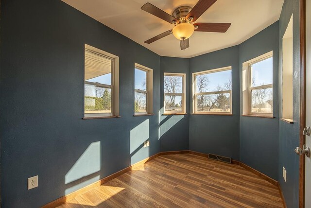 5628 E Eagle Dr, Milton, WI 53563 - empty room with visible vents, a ceiling fan, baseboards, and wood finished floors