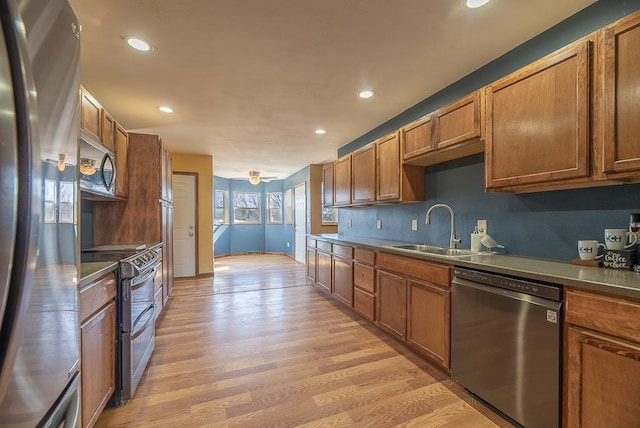5628 E Eagle Dr, Milton, WI 53563 - kitchen featuring a sink, stainless steel appliances, brown cabinets, and light wood finished floors