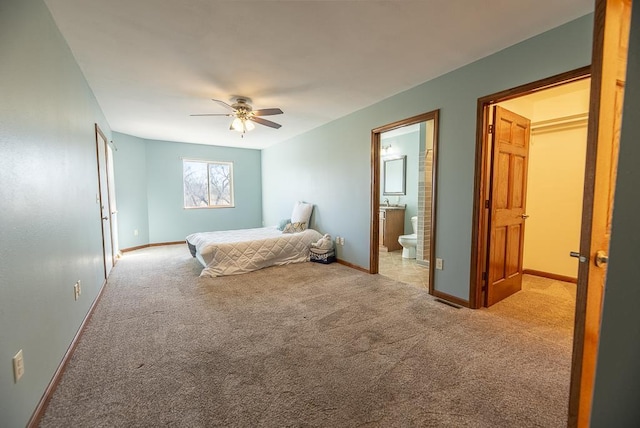 5628 E Eagle Dr, Milton, WI 53563 - unfurnished bedroom with visible vents, ensuite bathroom, carpet floors, baseboards, and ceiling fan