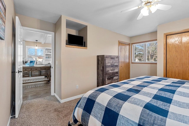 bedroom with carpet flooring, a ceiling fan, and baseboards