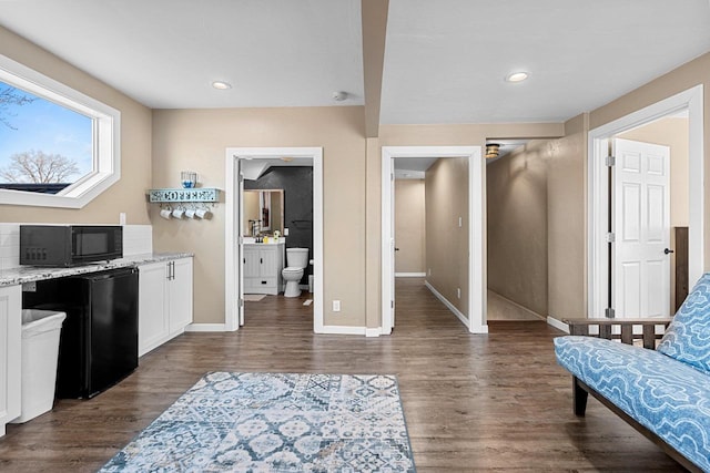 interior space featuring recessed lighting, baseboards, and dark wood-type flooring