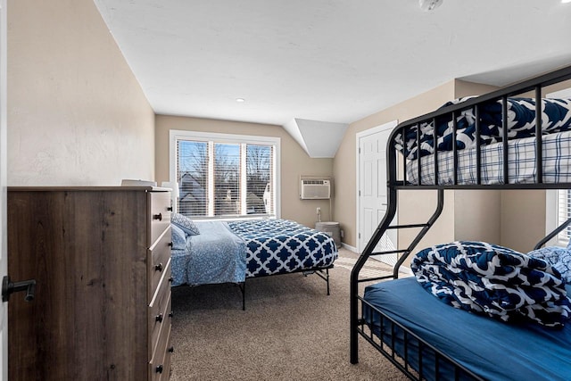 bedroom featuring baseboards, an AC wall unit, lofted ceiling, and carpet floors