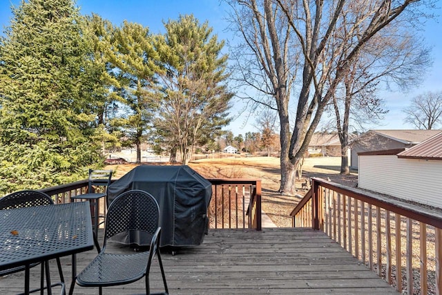 wooden terrace with a grill