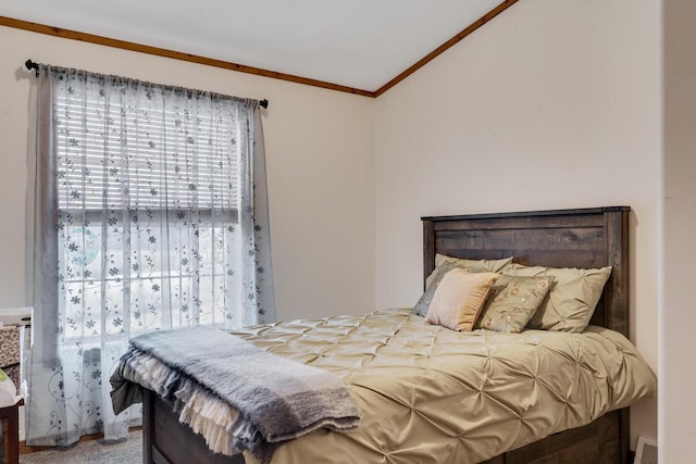 bedroom with crown molding and vaulted ceiling